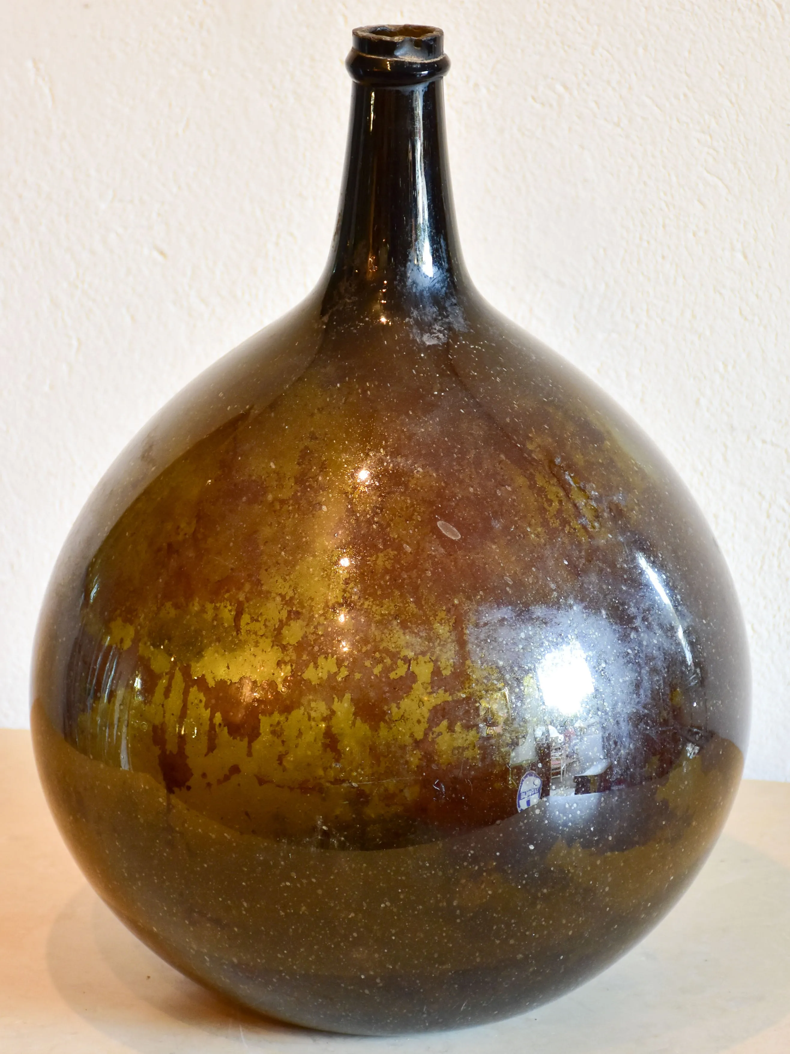 Antique demijohn bottle with dark Trinquetaille glass