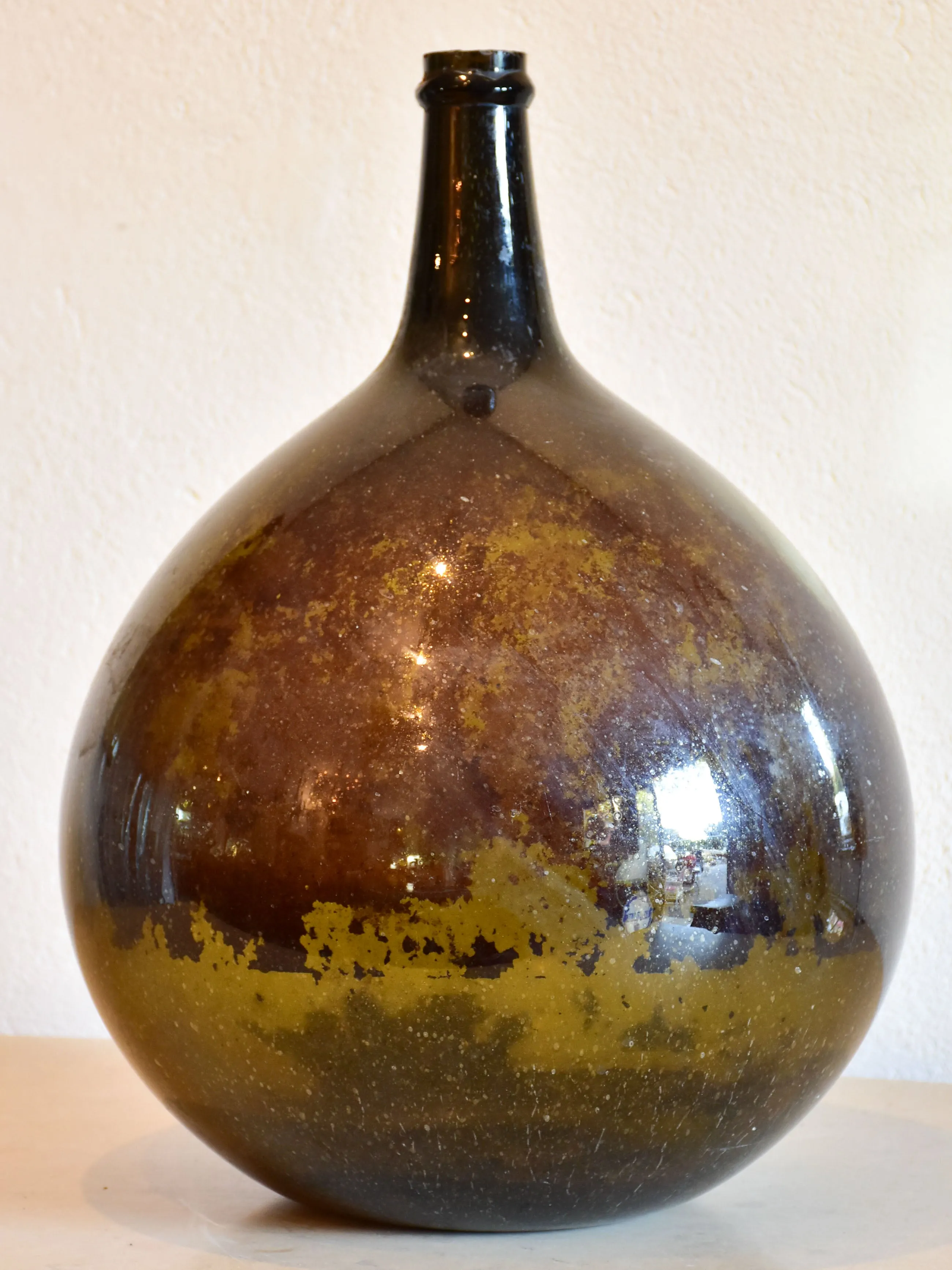 Antique demijohn bottle with dark Trinquetaille glass